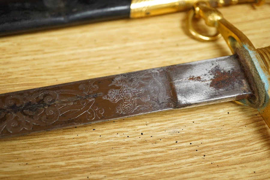 A post 1901 British naval officer’s dirk, the locket engraved with owners initials ‘CHCO’R’, regulation gilt brass mounts, with wire bound fish skin grip, bullion dress knot, in its original scabbard, blade etched with c